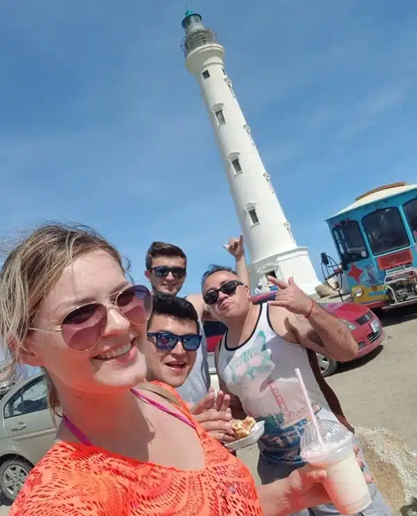 Enjoying cocktails with friends in front of the California Lighthouse Aruba