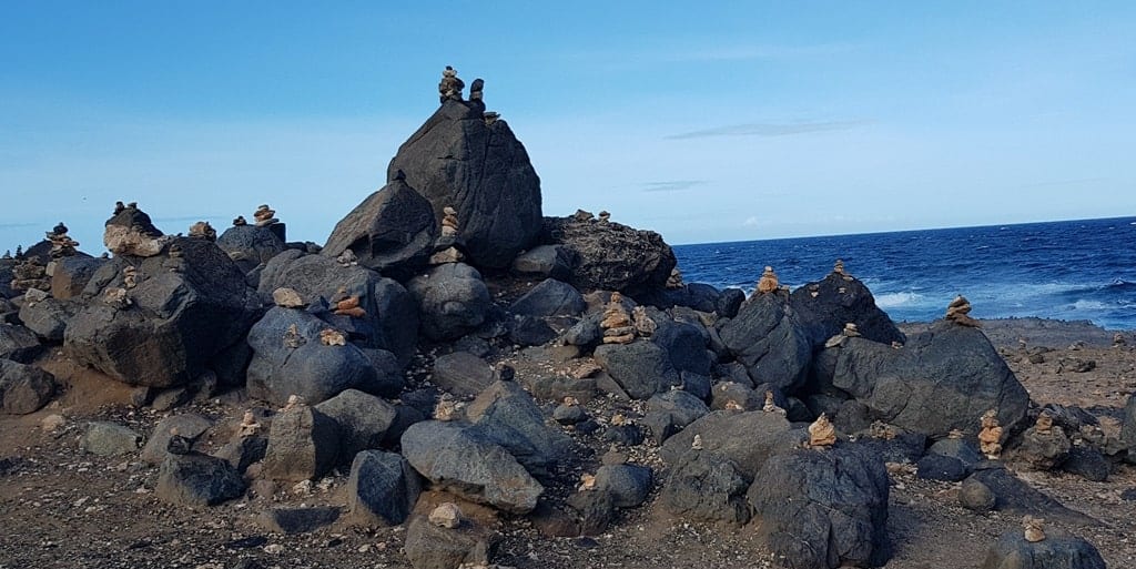 Black stone formations in the Natural Bridge area in Aruba