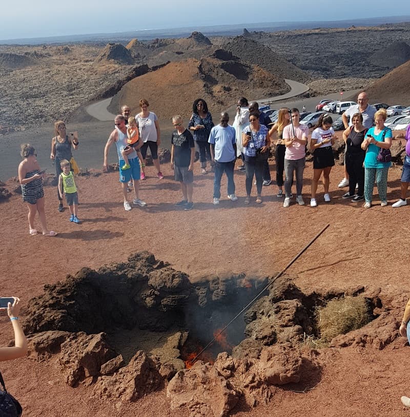 The demonstration of the fire coming out of the ground hole in El Diablo restaurant, Lanzarote