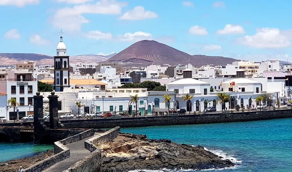 The bell-tower of the Church of San Ginés and Arrecife panorama. The picture was taken from the Castle of San Gabriel - you can see the Ball Bridge and two cannonballs on top of its pillars.